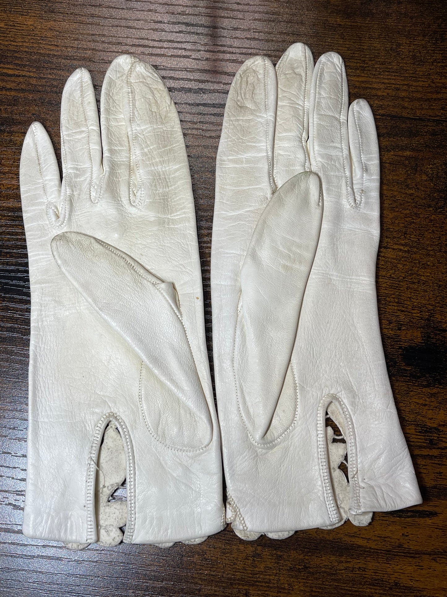 White leather gloves with floral cutout at wrist