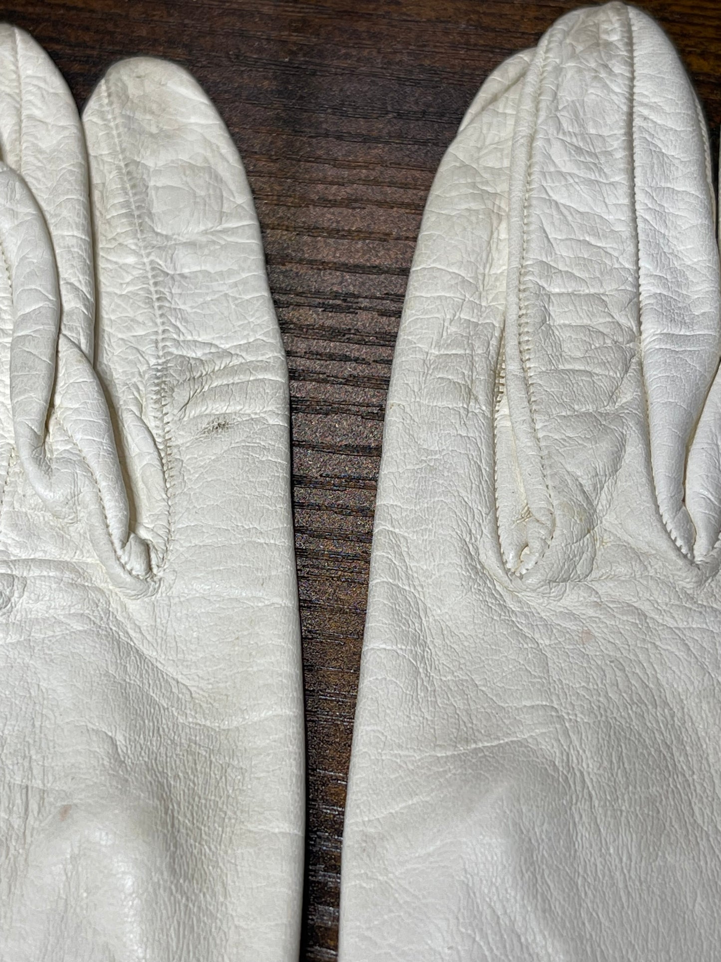 White leather gloves with floral cutout at wrist