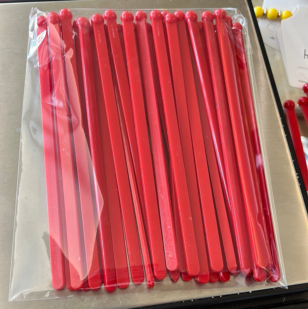 Red plastic drink stirrers
