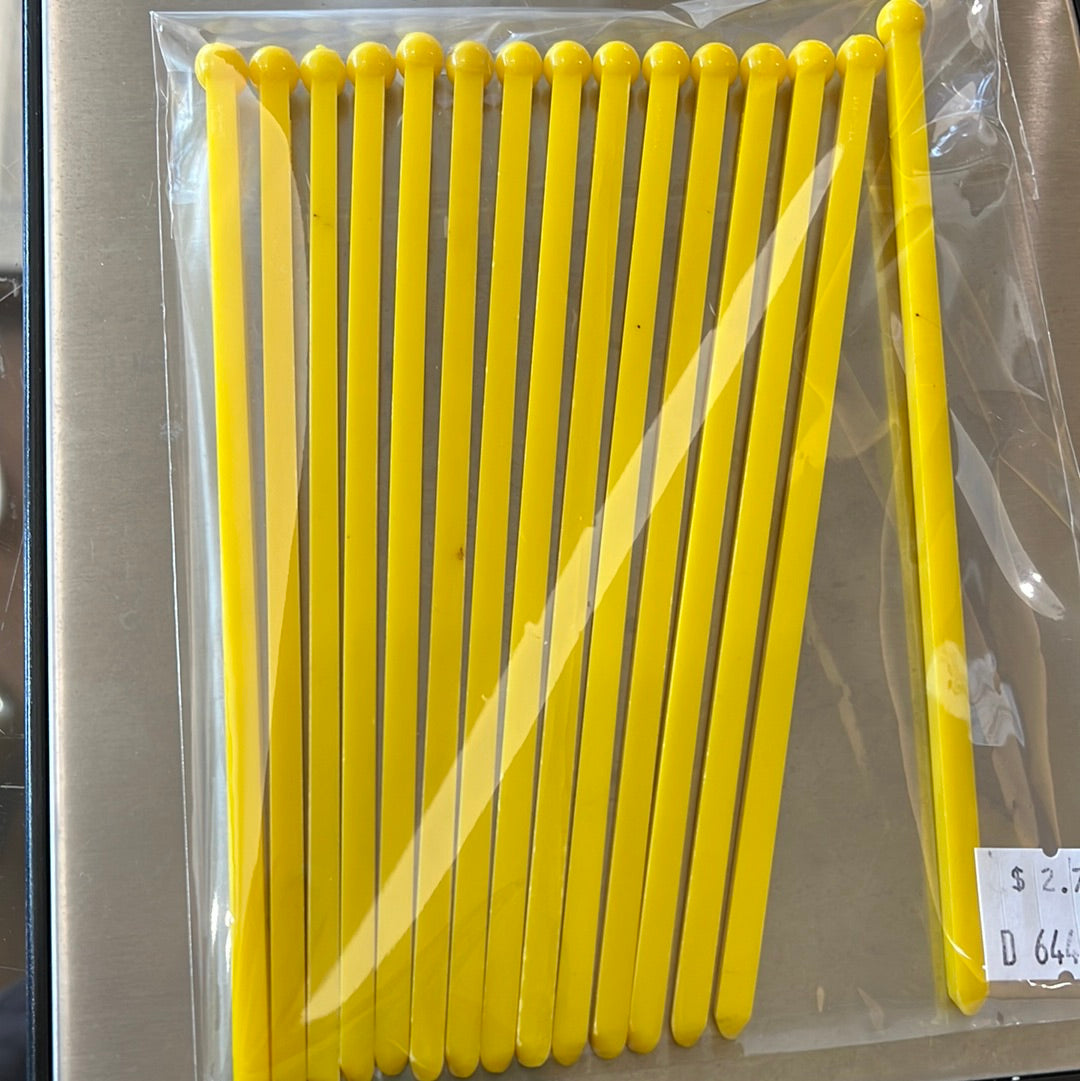 Yellow plastic drink stirrers