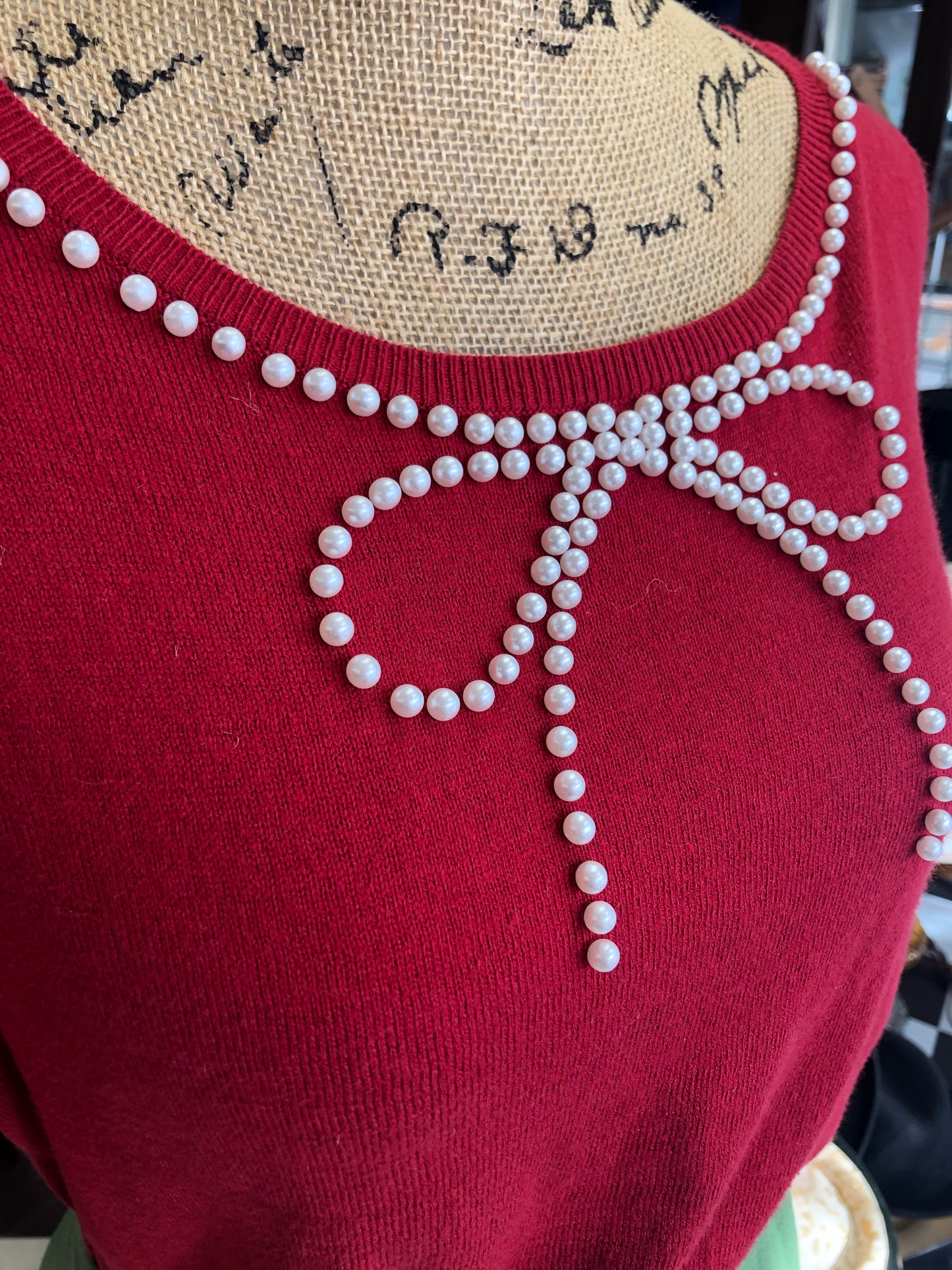 Red sweater with pearl bow collar