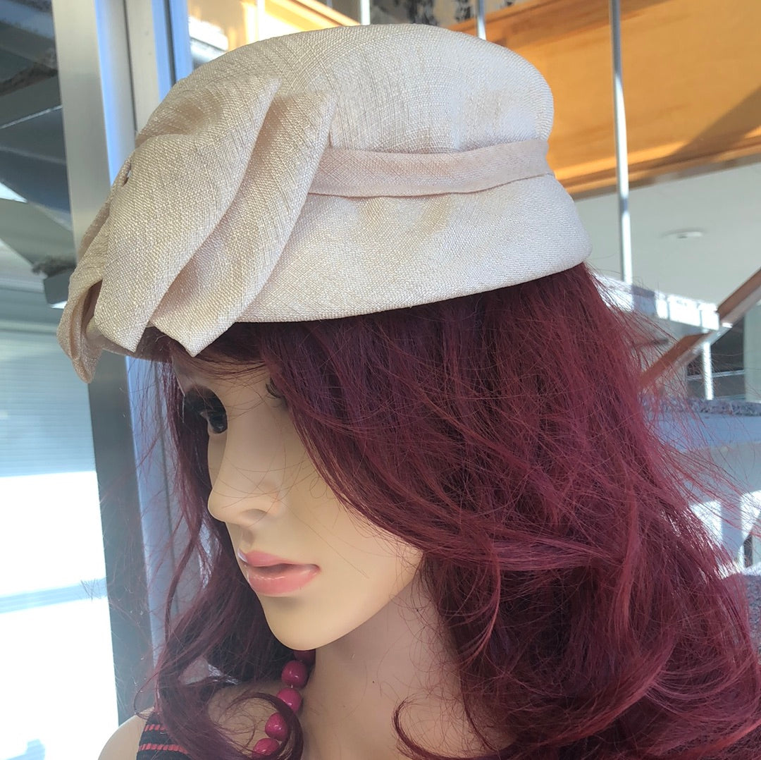 Beige textured fabric hat with bow