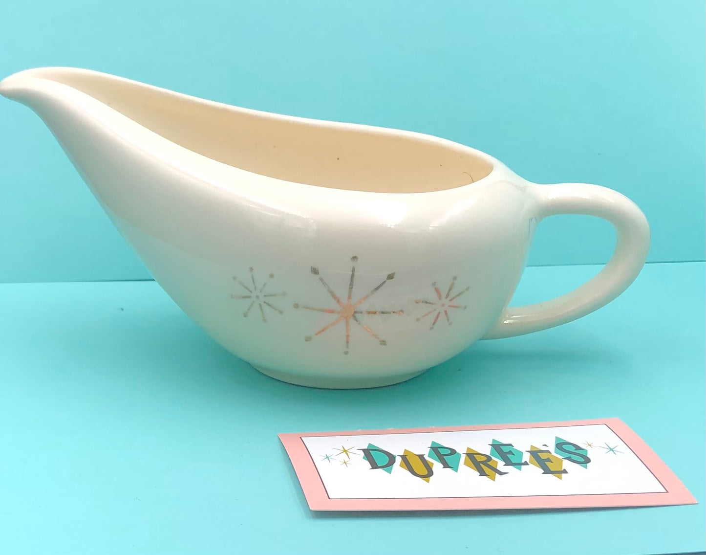 Ivory stone wear gravy server with gold star pattern