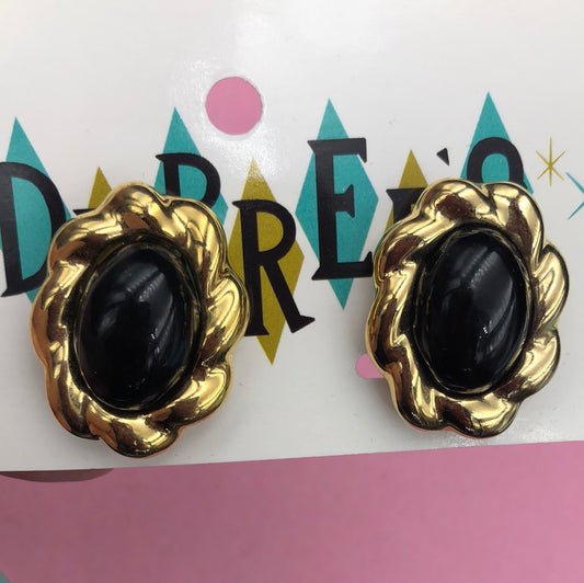 Gold oval clip on earring with Black center