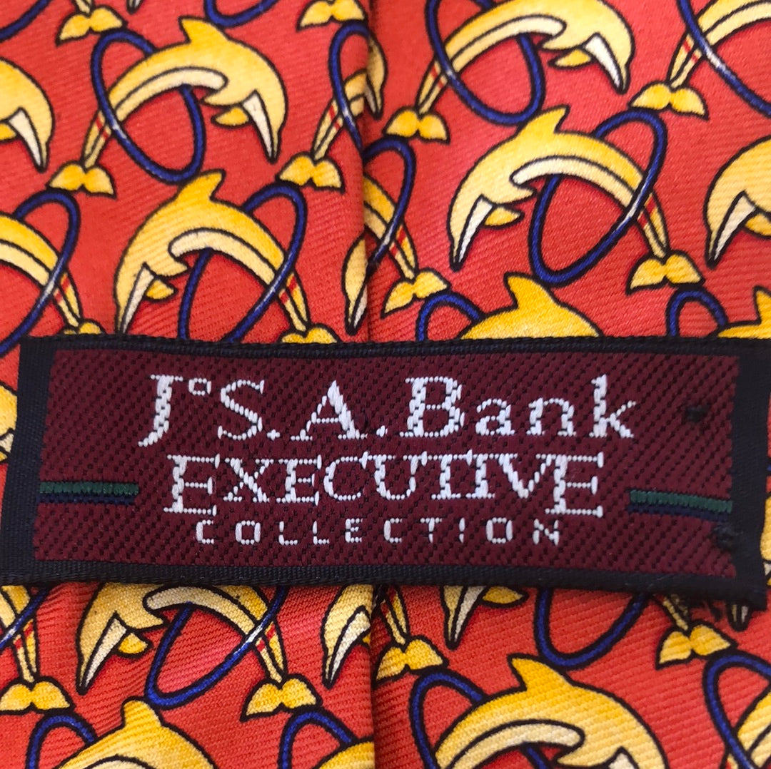 Red tie with yellow dolphins jumping through hoops