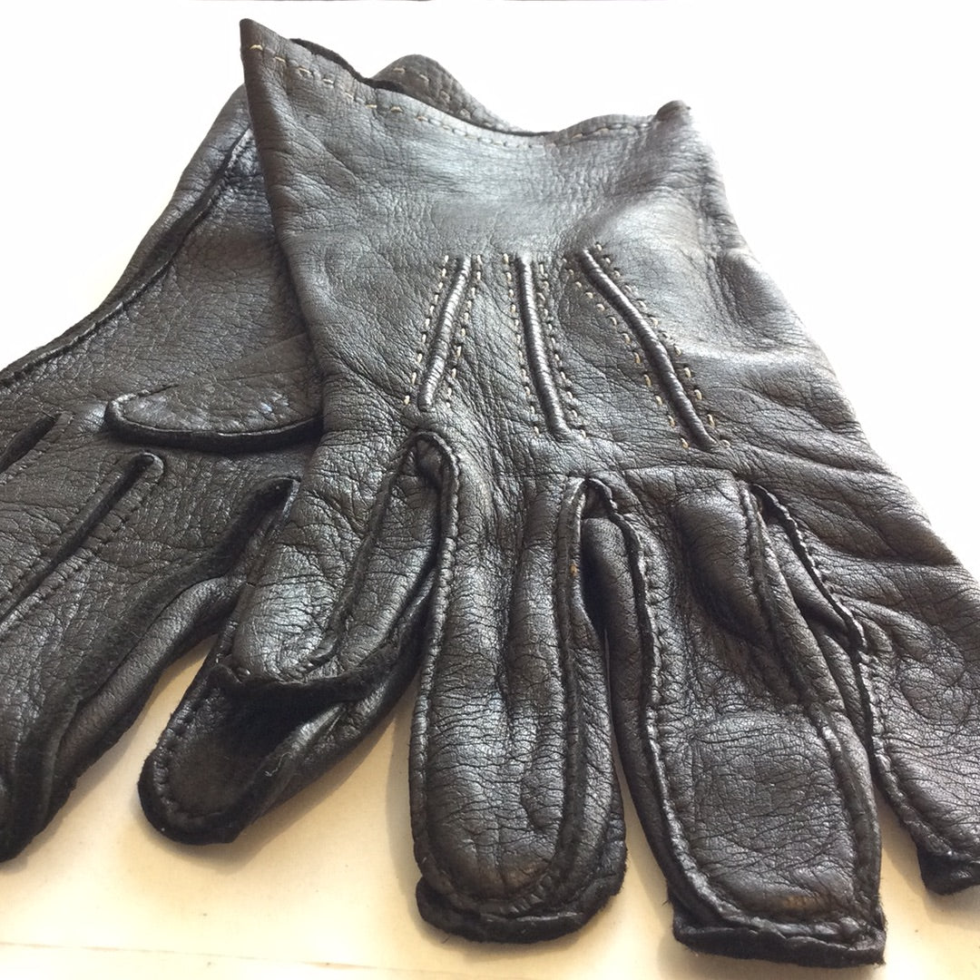 Black leather gloves with white stitching