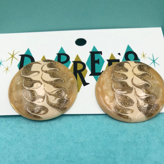 Round beige clip on earring with swirly design