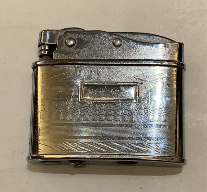 Spring loaded swing top lighter