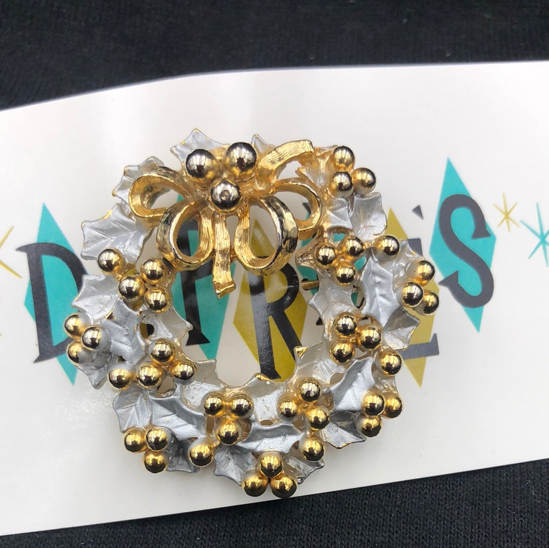 Silver holly wreath pin with gold berries and bow