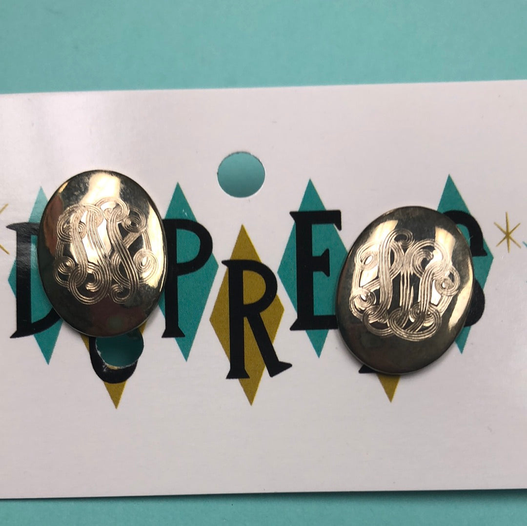 Gold oval clip on earring with etched design