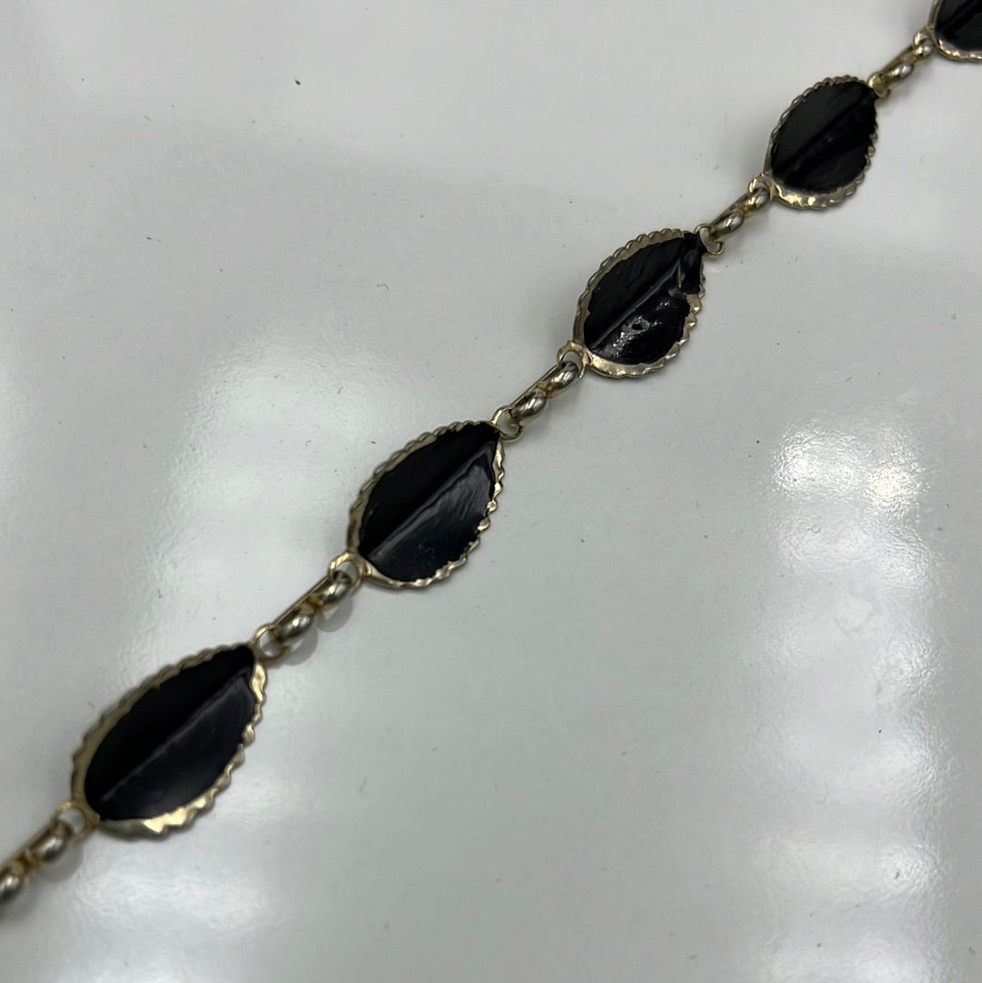 Gold 14” necklace with black teardrop leaves