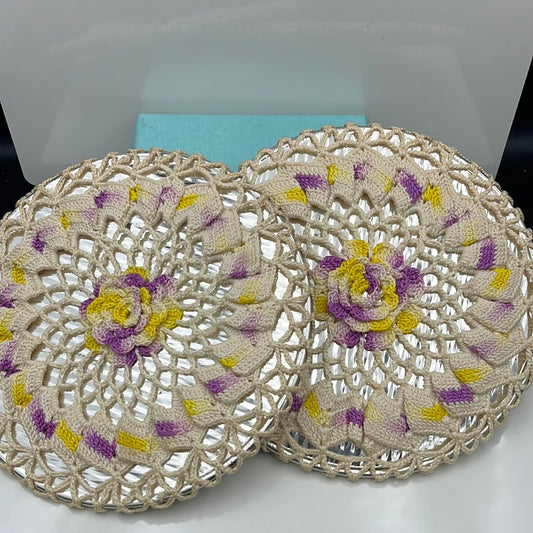 2 trivets with crocheted cover