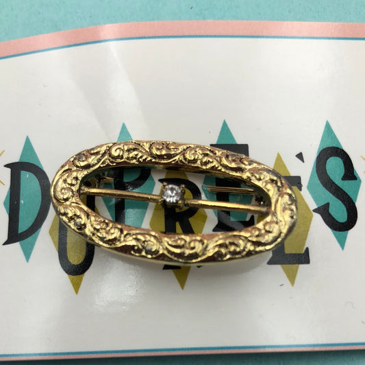 Gold oval pin with crystal center