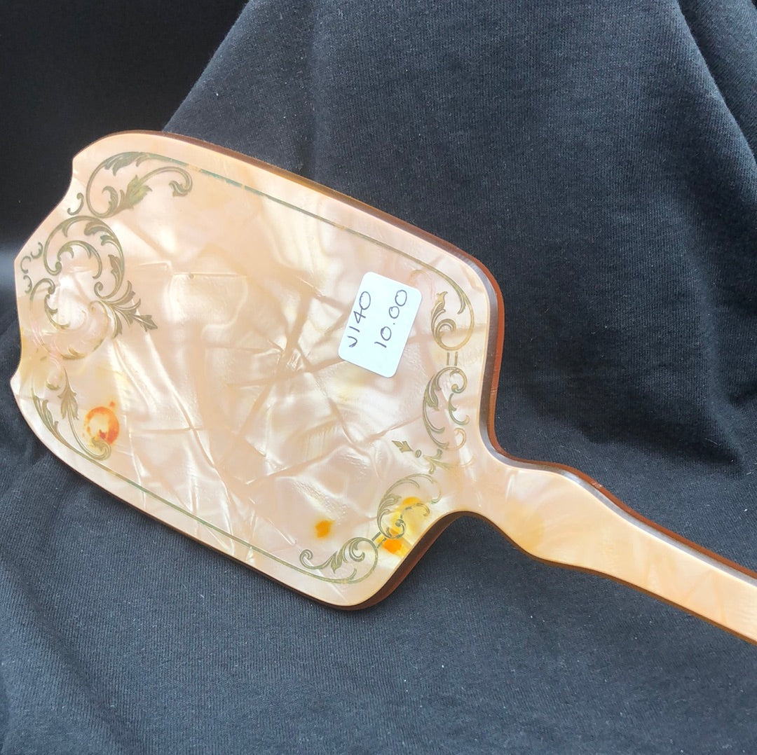 Oval hand mirror with amber handle