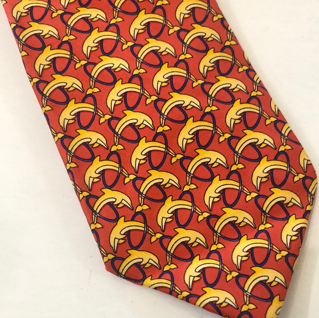 Red tie with yellow dolphins jumping through hoops