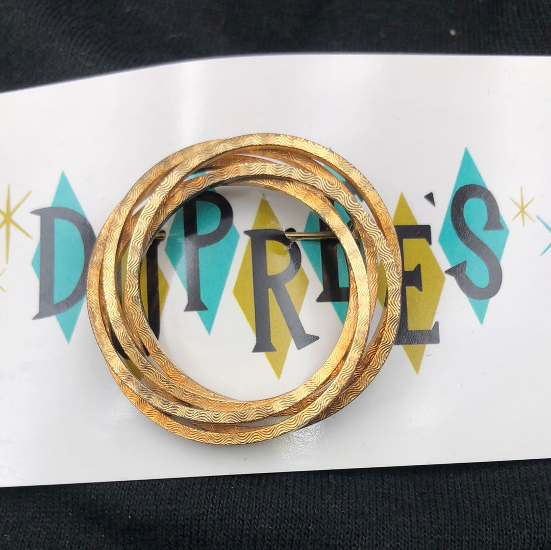 Entwined gold textured circle brooch