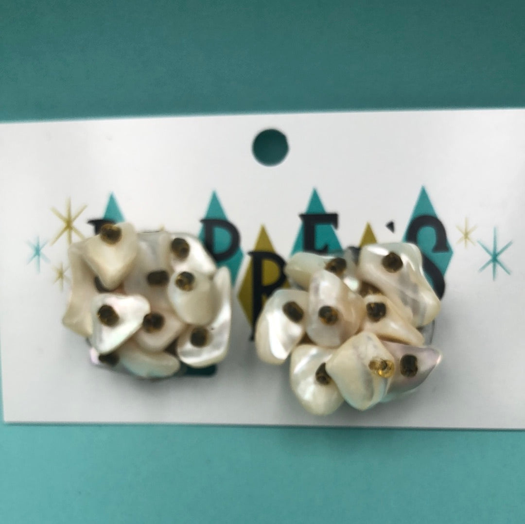 Ivory shell pieces in a cluster with a clip on back