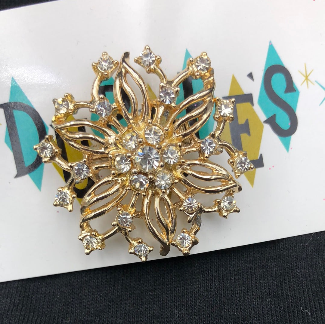 Gold flower/snowflake brooch with clear crystal